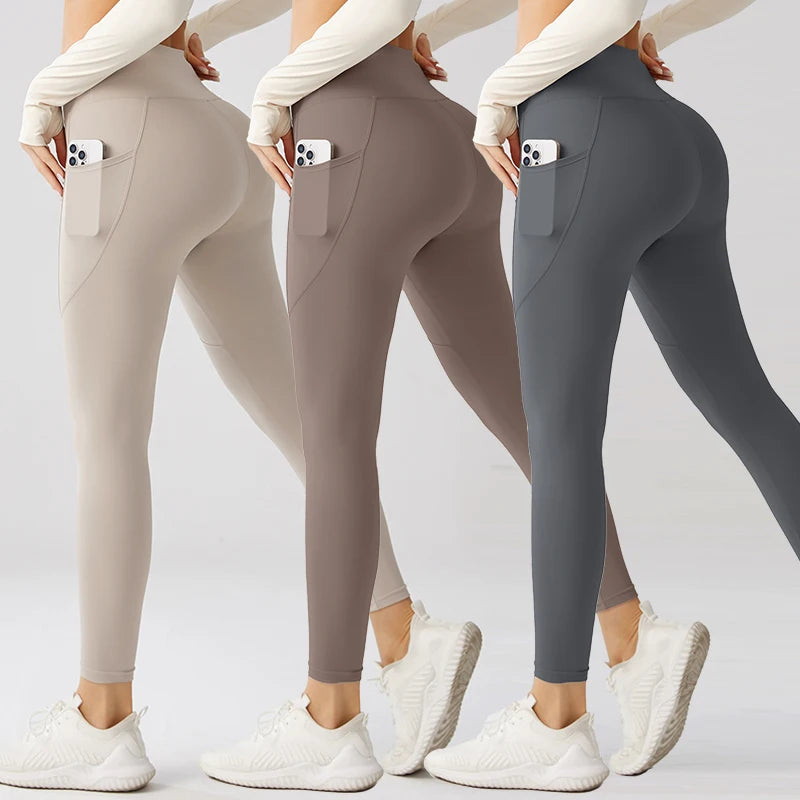 Three pairs of leggings in beige, brown, and gray with pockets on a light gray background.